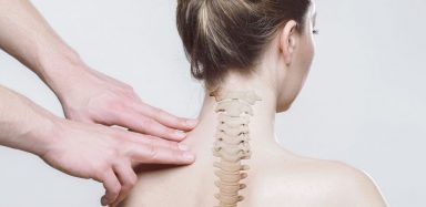 Someone examining someone's spine.