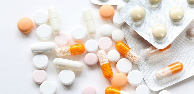 White and orange pills on a table