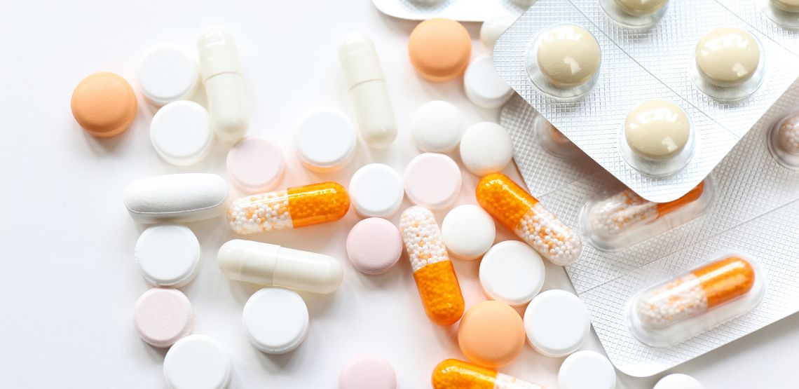 White and orange pills on a table